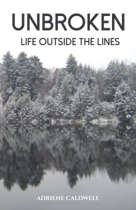 Cover scene of trees reflected in a lake, Unbroken: Life Outside the Lines