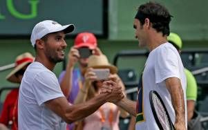 Adrian Escarate with Roger Federer